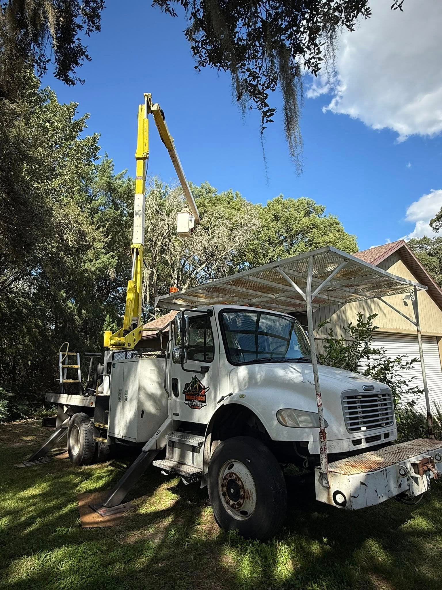 Professional tree service worker in safety gear operating equipment in Ocala, Florida
